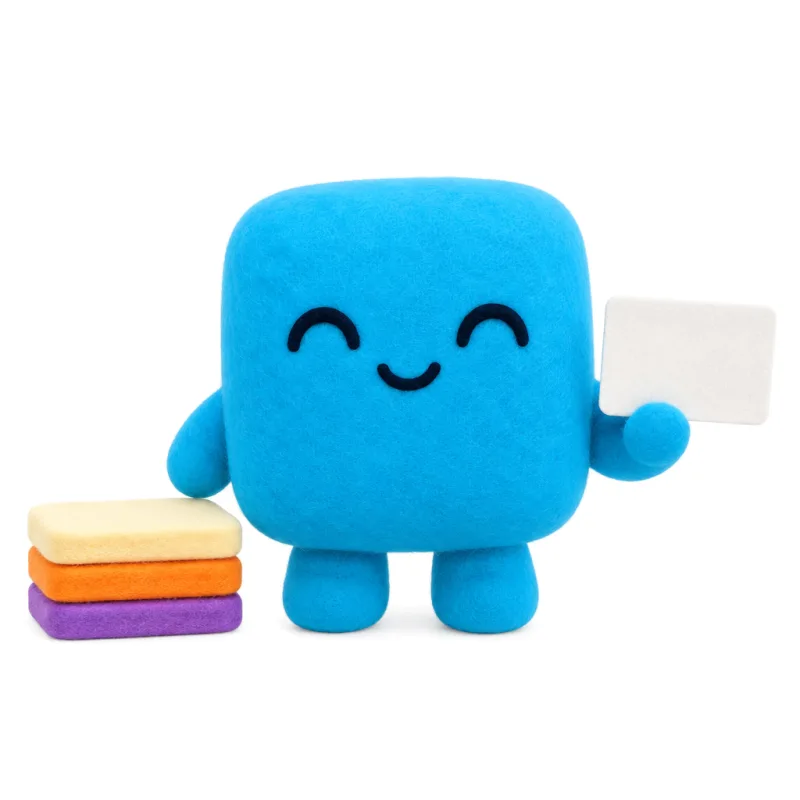 A plush character next to a small stack of coloured cards